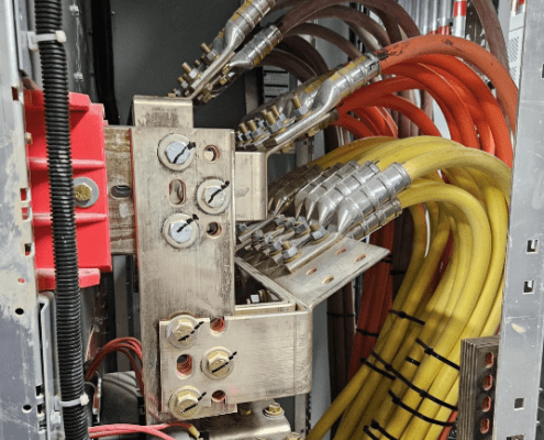 An electrical panel with a complex network of industrial wiring and crimped connectors, highlighting the importance of reliable terminations.