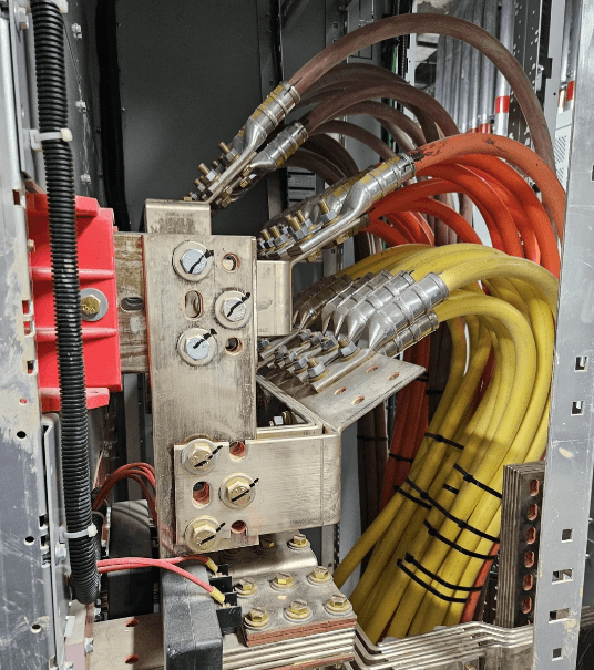 An electrical panel with a complex network of industrial wiring and crimped connectors, highlighting the importance of reliable terminations.